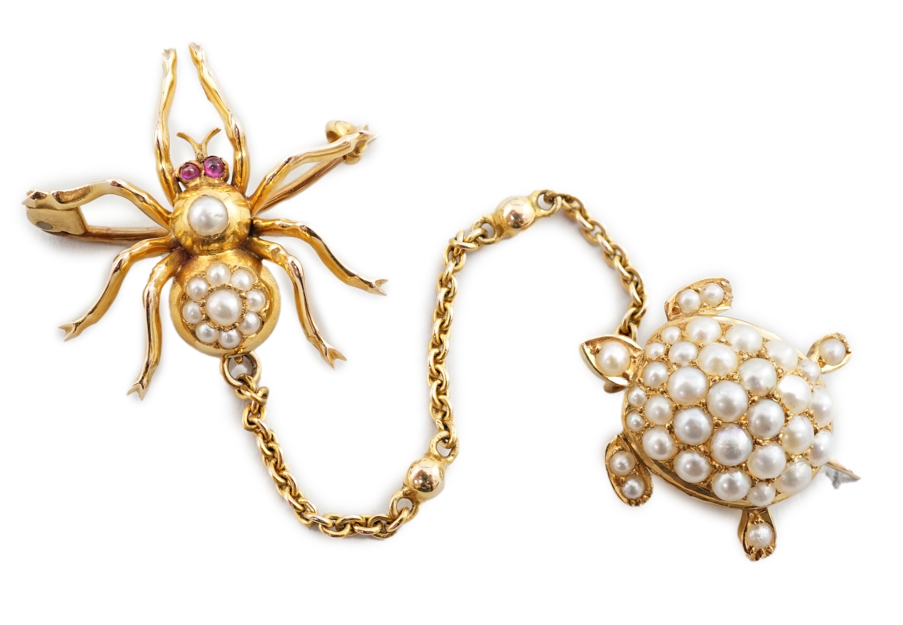 A late Victorian gold and seed pearl set brooch with suspension chain and clip, modelled as a spider with turtle